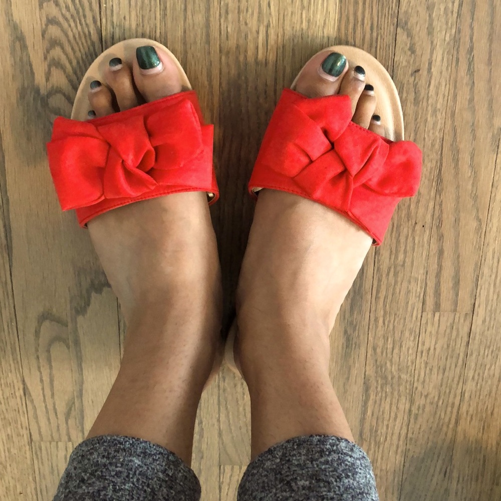 Red bow flat sandals.